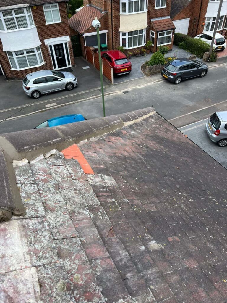 This is a photo of a hip roof where the bonnet tiles have just been replaced due to damage. Works carried out by Calverton Roofing Repairs